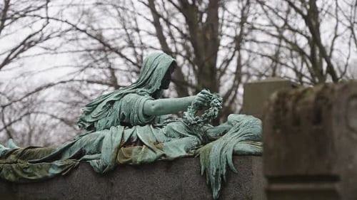 Bronze grave statue with rain 30p Slow Motion)