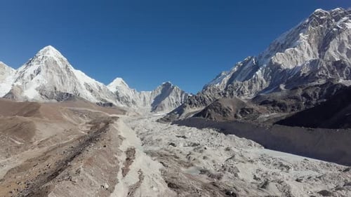 Aerial View of a Majestic Glacial Valley in the Himalayas of Nepal Showcasing Towering Snowcapped