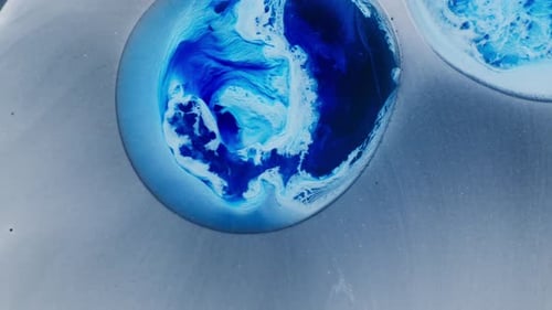 Swirling blue alcoholic ink shot creating a dreamlike abstract fluid pattern