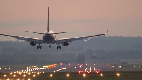 The plane lands at the airport.