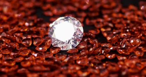 Diamond Shimmers Among Faceted Red Gems