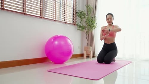 Woman Doing Plank Exercises Indoors on a Yoga Mat
