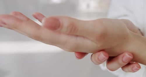 Woman Applies Moisturizing Lotion to Hands Close Up