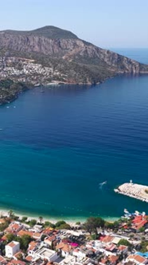 Vertical Video of Small Harbor With Sea Waves and Docked Boats