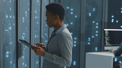 Woman Using Tablet in Modern Server Room