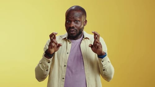A Comedic Video Features a Man with Funny Faces in a Yellow Background