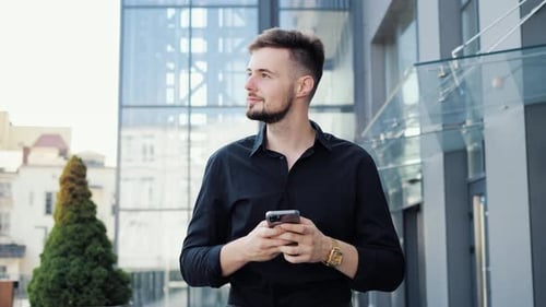 Businessman Looking at Smartphone Messaging Online in Social Media Outdoor