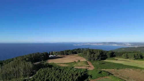 Panoramic View Of Forested Mountains And Coastal Town In Summertime