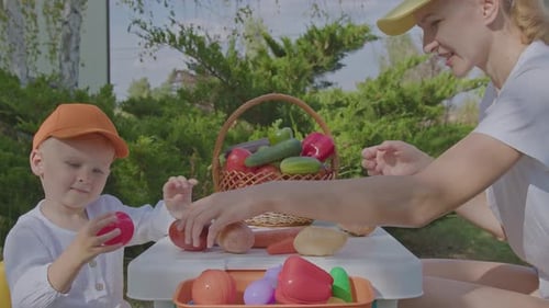 Three Year Old Boy And His Mother Learning Vegetables In Home Garden 1