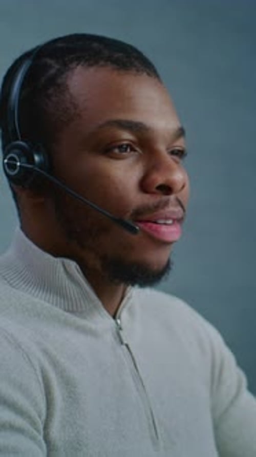 Close Up of African American Technical Support Specialist in Headset Consulting Client on Call