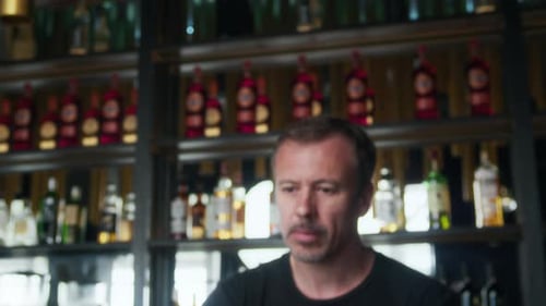 Adult Bartender Adding Ice Making Cocktail in Restaurant with Modern Interior