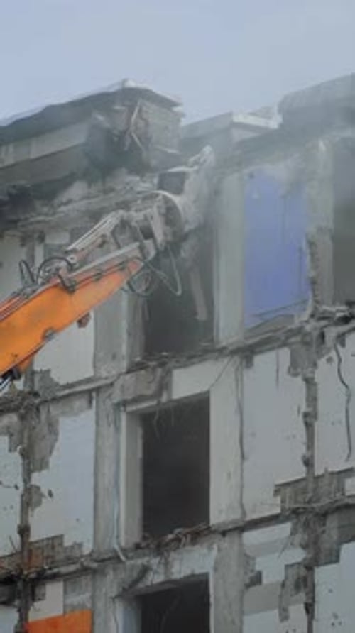 Crane Demolishing Building Structure in Vertical Format