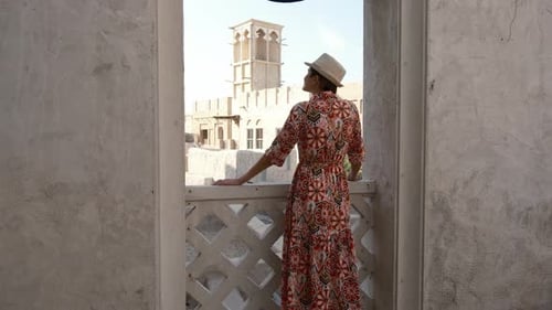 Woman in Dress and Hat Exploring Al Seef Park in Dubai