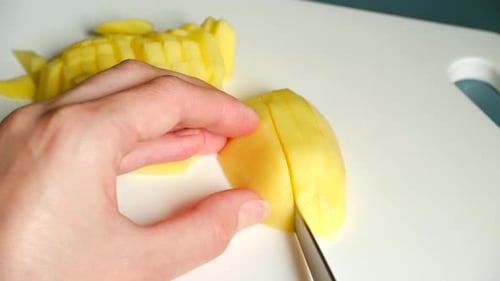 Close-up of Dicing a Potato on Cutting Board