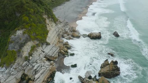Aerial View of Rocky Coastline with Crashing Waves