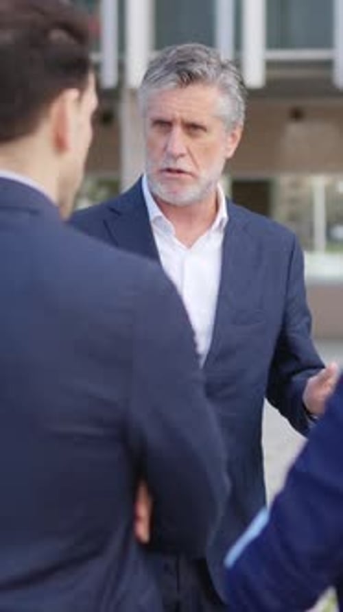 Business Colleagues Talking About Work Outside Office