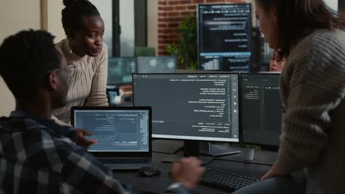 Software Development Team Reviews Coding Project at Development Workstation