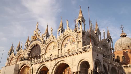 St. Mark's Basilica glows under the golden evening sun in Venice Italy