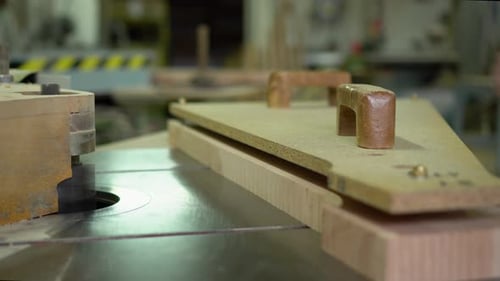 Woodworker Shaping Wood Block with Machine in Workshop