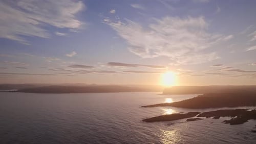 Silhouetted Islands And Shimmering Norwegian Waters At Sunset