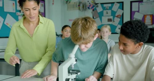 Students Learning Science Using Microscope in Classroom