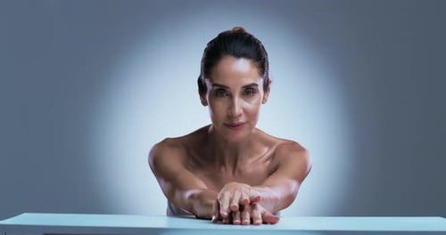 Glamorous Woman Posing with Grace in Studio Setting