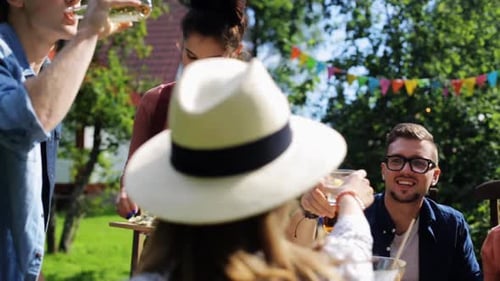 Leisure, Holidays, Eating, People And Food Concept - Happy Friends Having Dinner At Summer Garden...