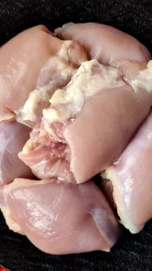 Raw chicken thigh fillet, boneless and skinless, for roasting. Raw thigh fillet