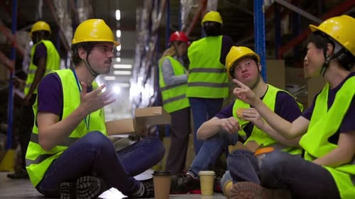 Warehouse workers chatting during lunch break