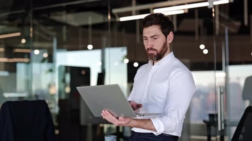Businessman Using Laptop in Modern Office Confident Male Entrepreneur Working Online