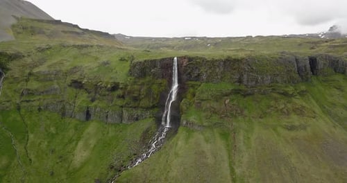 Aerial view of Large waterfall with green landscape in Iceland