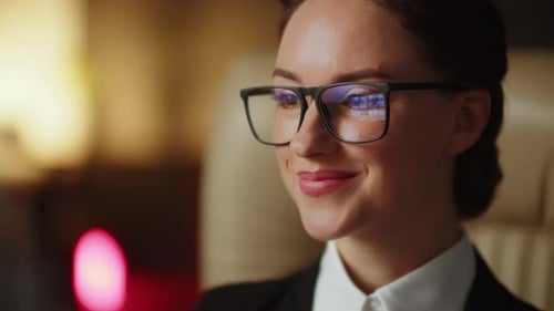 A Young Business Assistant Girl Looking Some Videos in Glasses Reflection Cheerful Woman in Office