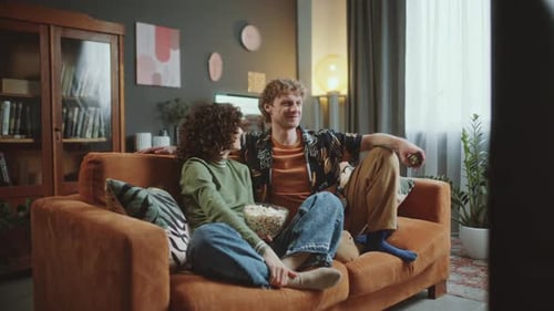 Couple Relaxing on Sofa Watching TV