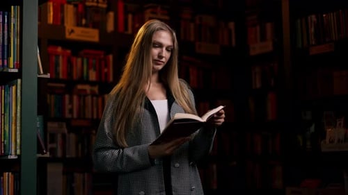 Young Woman Reading Book in Library