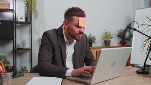 Frustrated Office Worker Wearing Loser Sticky Note