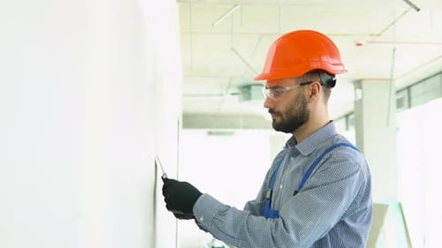 Plasterer Construction Worker Plastering the Wall Inside the Building Site