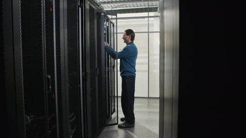 Network Engineer Connecting Cable and Installing Server in Data Center