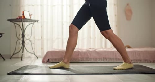 Woman Doing Lunges on Yoga Mat Indoors