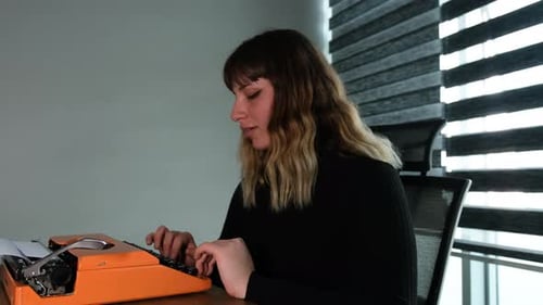 Woman typing on retro typewriter