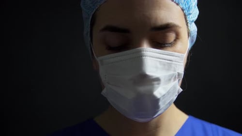 Health Medicine and Pandemic Concept - Sad Young Female Doctor or Nurse