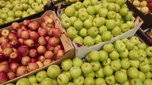 High Angle of Neatly Arranged Green and Red Apples Placed in Cardboard Boxes