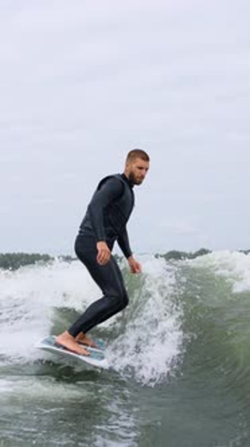 Man Surfing on Wave