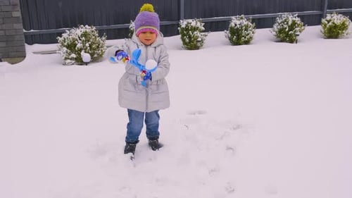 Girl Playing in the Snow in Wintertime