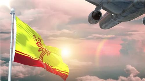 Waving Flag and Airplane Flying Across a Sunset Sky