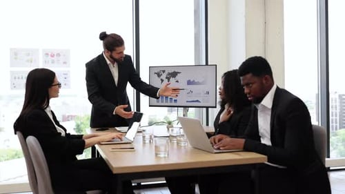 Confident Team Discussing Business Strategy in Modern Office