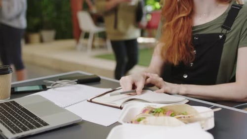 Woman Studies with Laptop and Tacos Outdoors