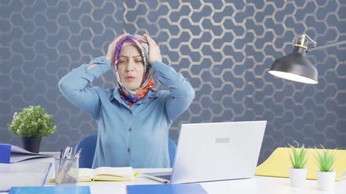 Hijab business woman suffering from migraine.