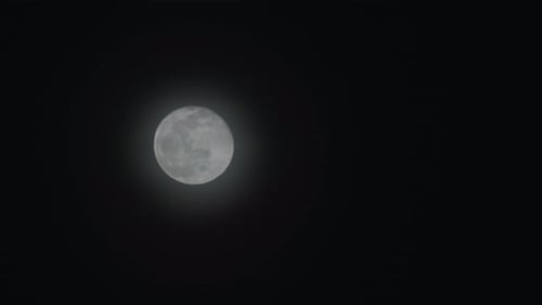 Full Moon Moving Across Dark Sky at Night