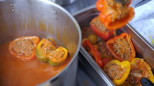 Chef Plating Stuffed Bell Peppers With Tongs