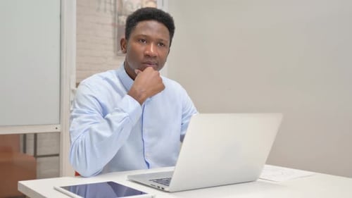 Young Adult Working on Laptop at Desk